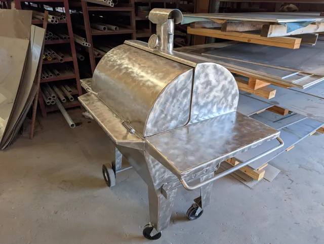 Custom stainless steel barbecue pit smoker on wheels fabricated in the shop